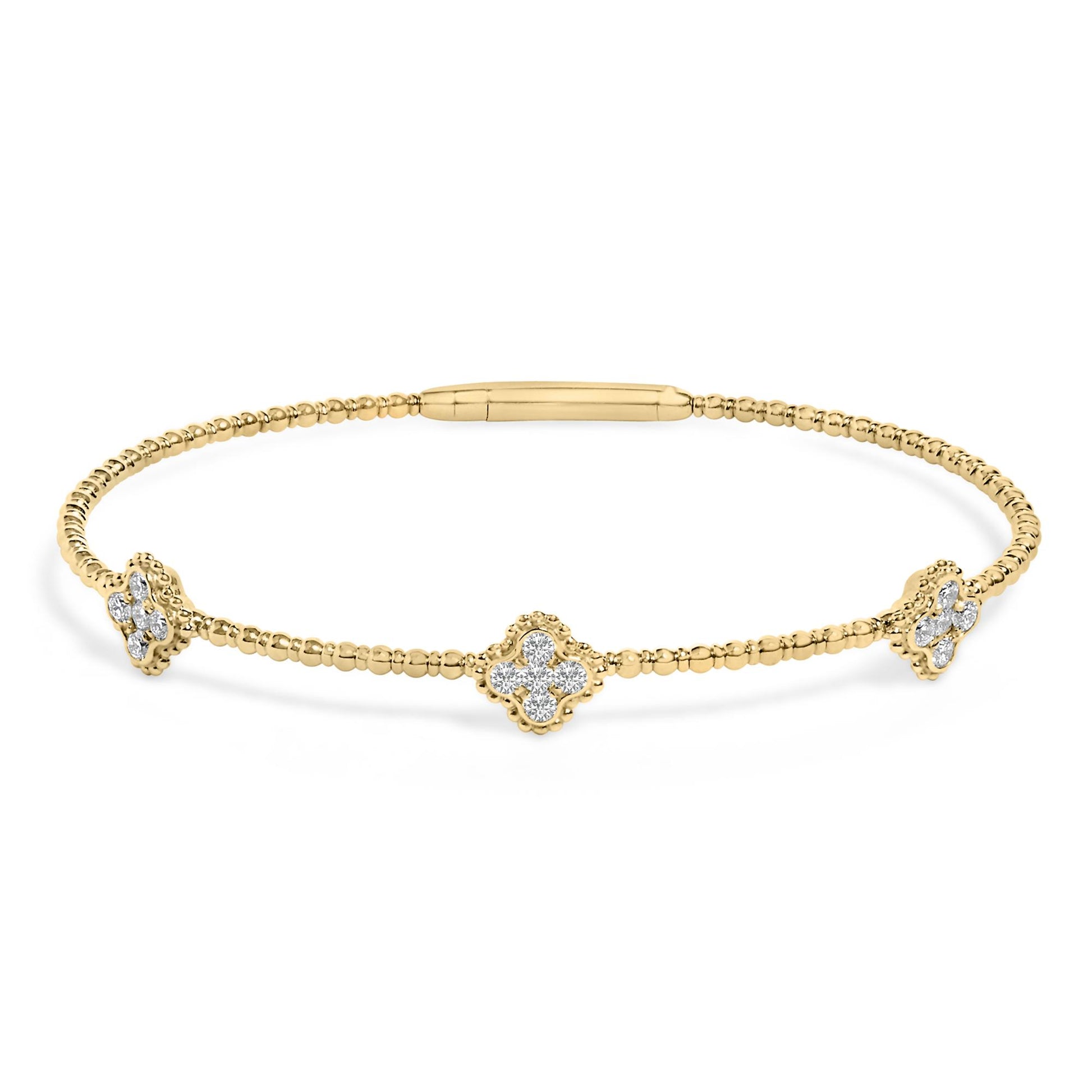Yellow bracelet with round white gemstones in prong settings arranged in floral shapes, shown in a front-facing angle on a white background.