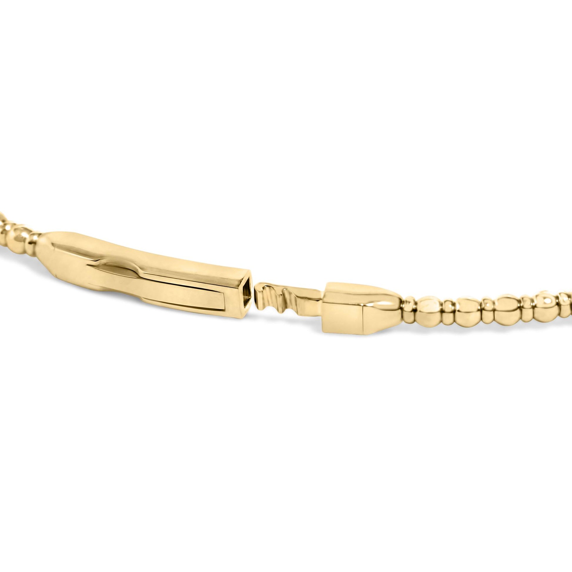 Close-up side angle of an open yellow metal bracelet clasp with rounded bead details along the band, shown on a white background.