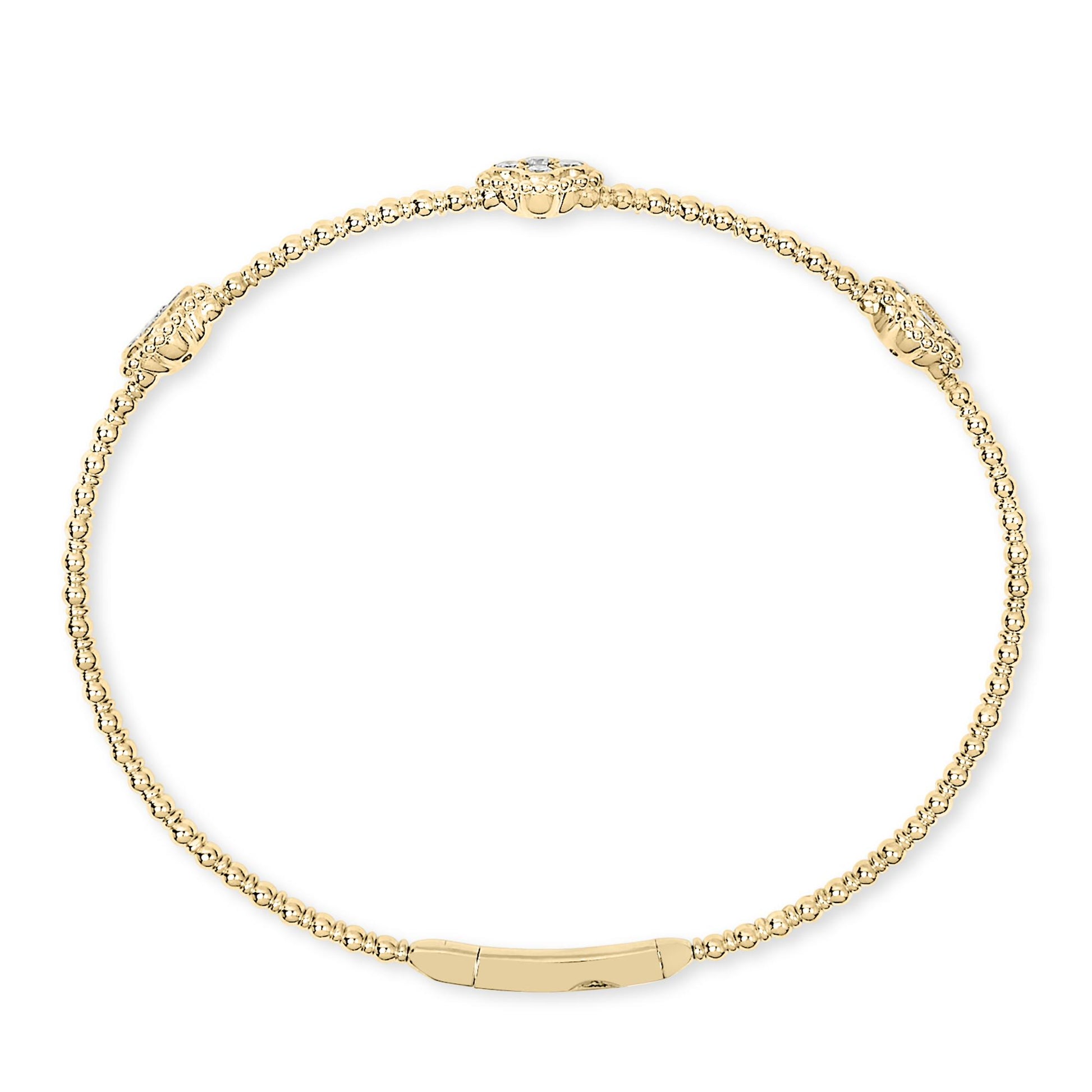 Top-down view of a yellow bracelet composed of small round beads with three larger bead clusters each set with a white round gemstone in prong settings.