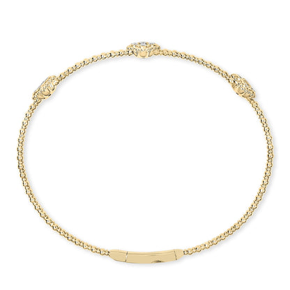 Top-down view of a yellow bracelet composed of small round beads with three larger bead clusters each set with a white round gemstone in prong settings.