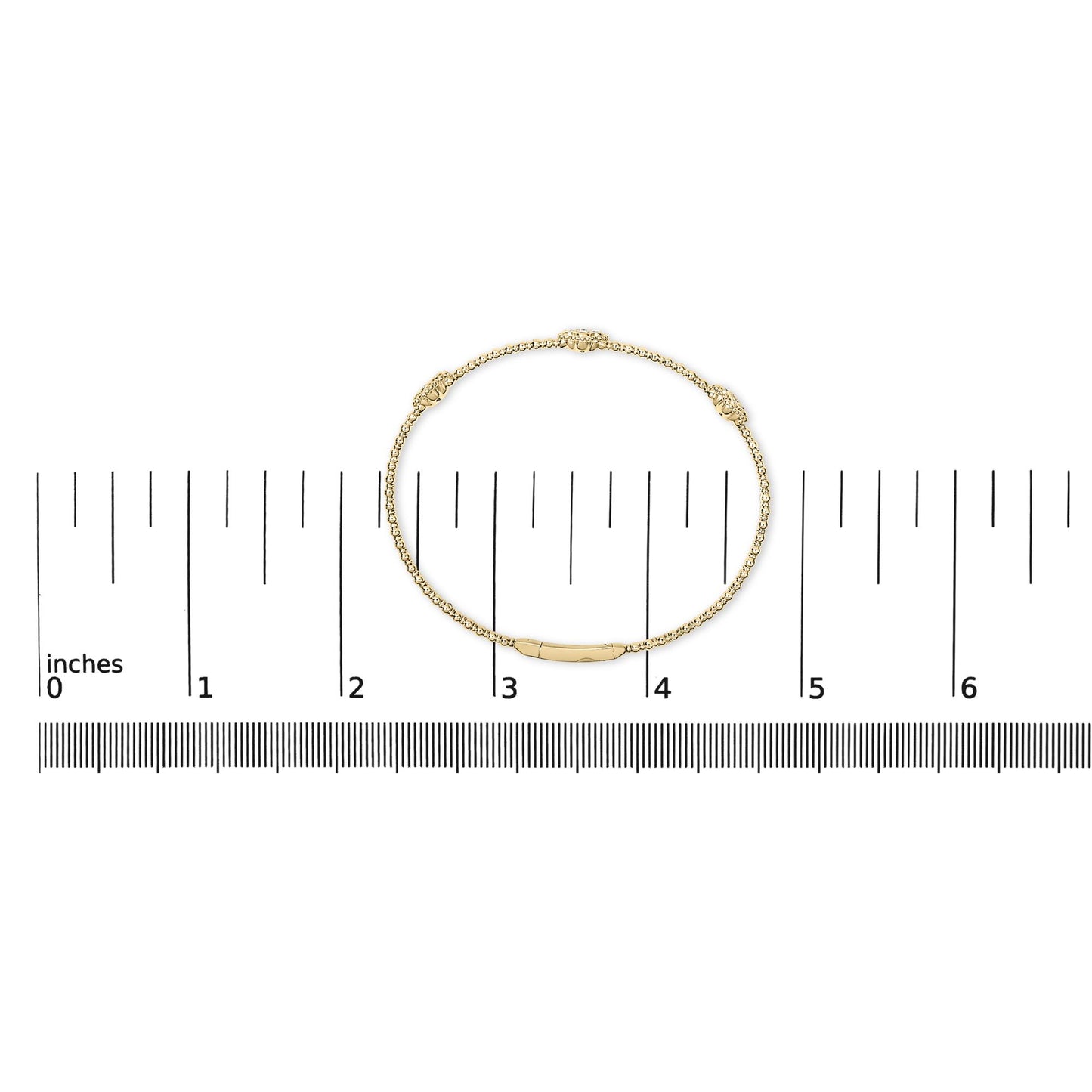 Bracelet with round white gemstones in prong settings and decorative elements on a yellow metal chain, shown flat on a measurement scale from a top-down angle.