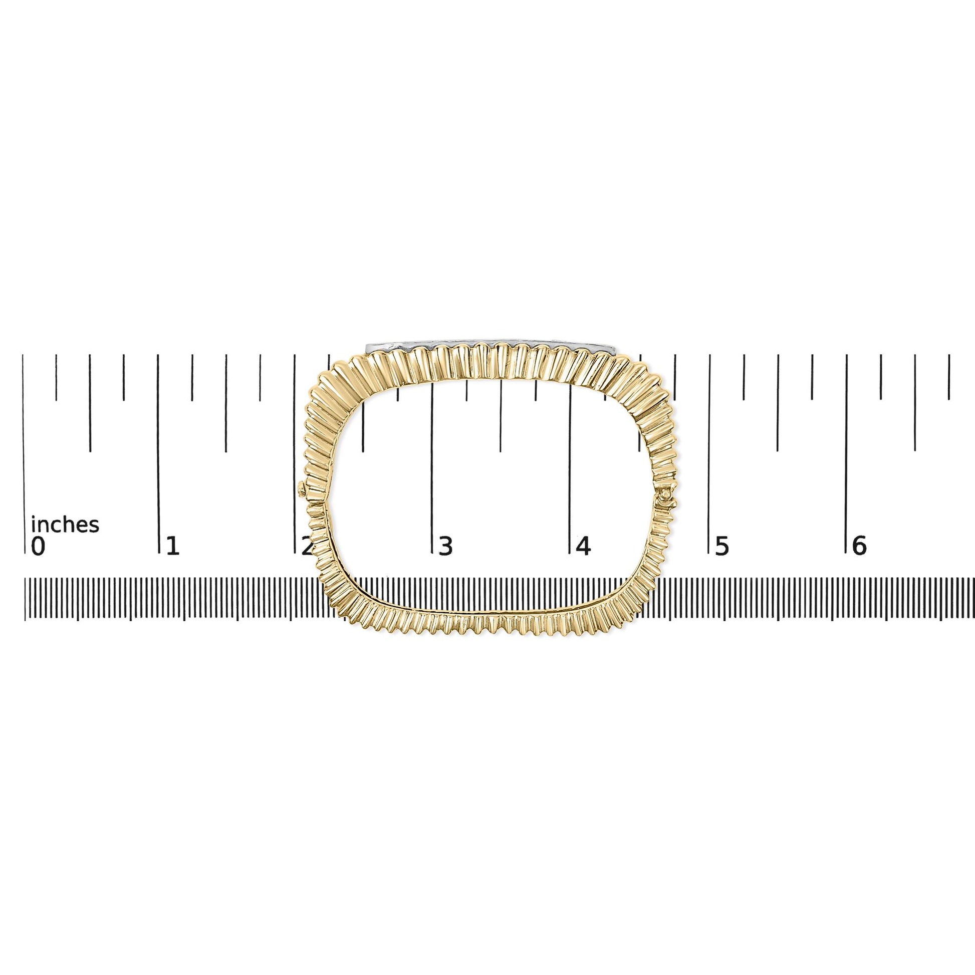 Top-down view of a yellow bracelet with a ridged design and a row of white round pave-set gemstones, shown on a scale.