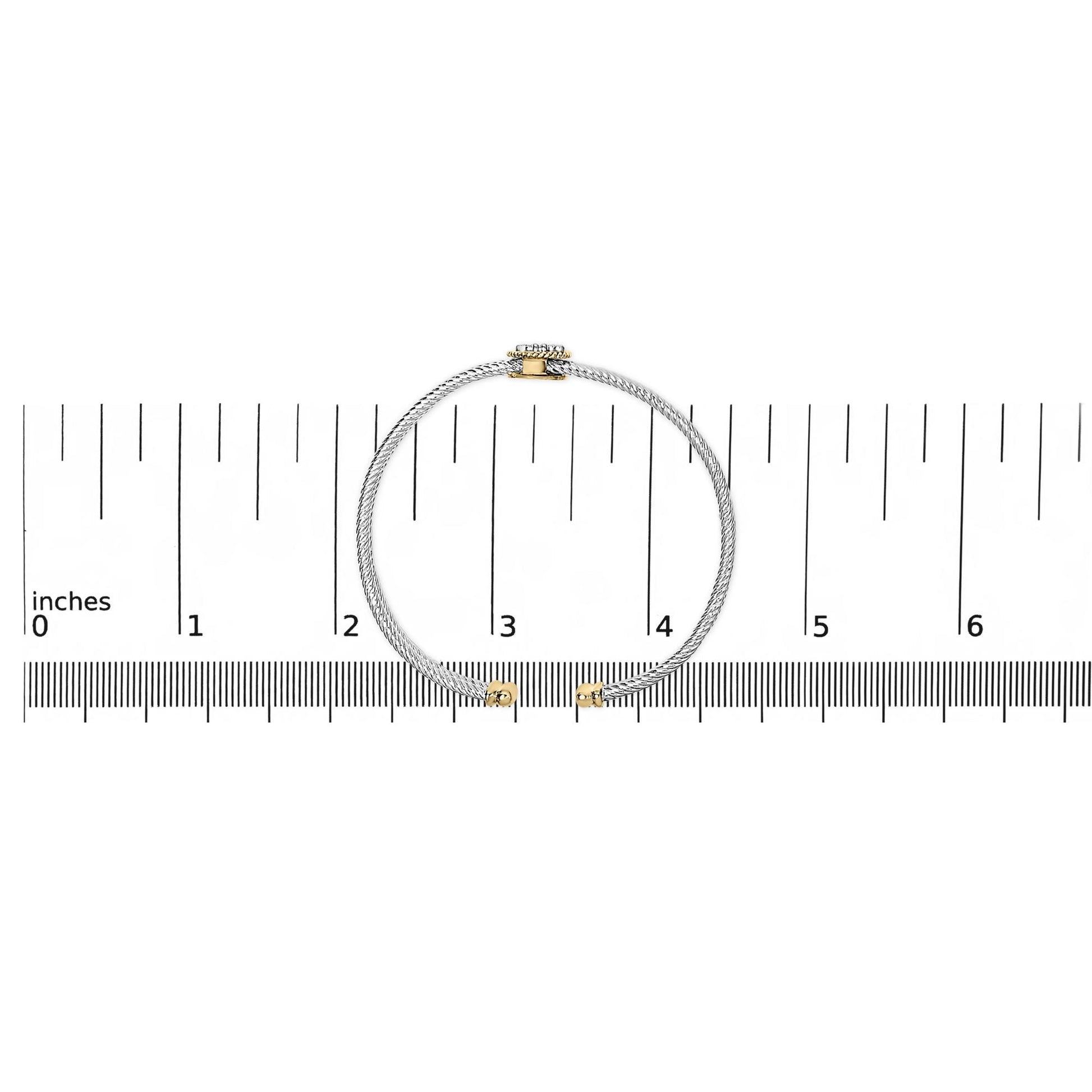 Bracelet with twisted white metal band and yellow metal accents, featuring round white gemstones in bezel and prong settings, shown flat on a scale from top view.