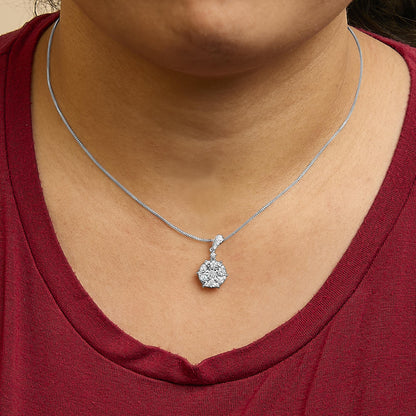 Close-up front view of a white metal necklace with a round cluster pendant featuring a central white gemstone in a miracle setting surrounded by smaller white gemstones in shared prong and prong settings, shown worn on a model.