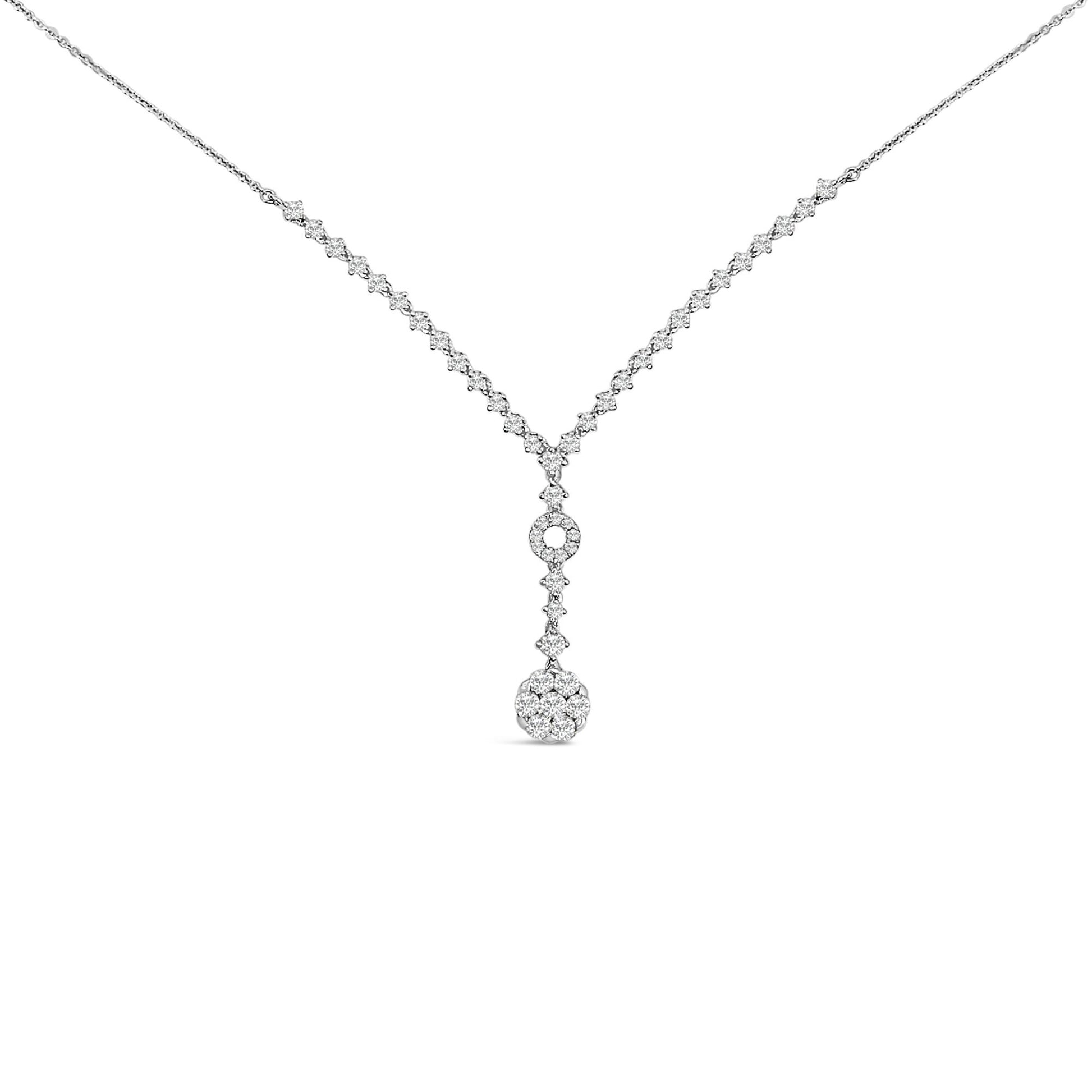 Front view of a white metal necklace with a V-shaped chain featuring small white gemstones and a circular pendant at the center with clustered white gemstones.