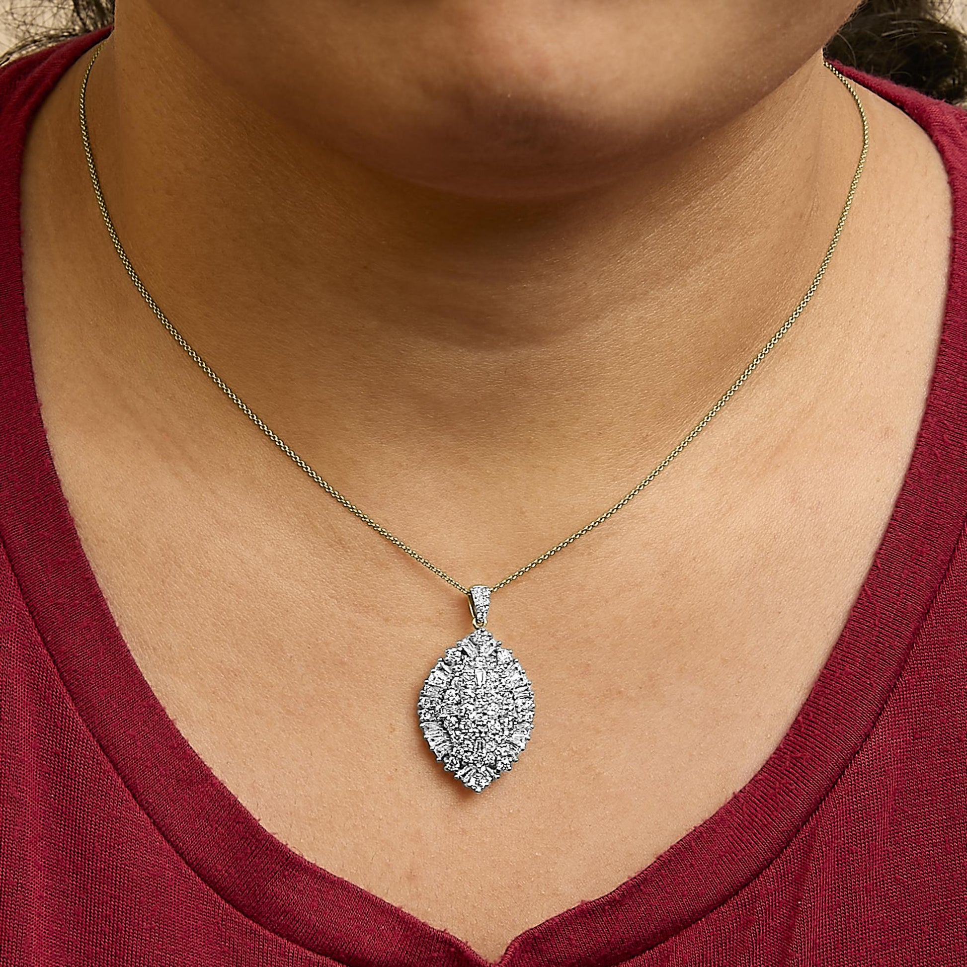 Necklace with marquise-shaped pendant featuring clustered white round and baguette gemstones in prong settings, shown worn on a model, front close-up angle.