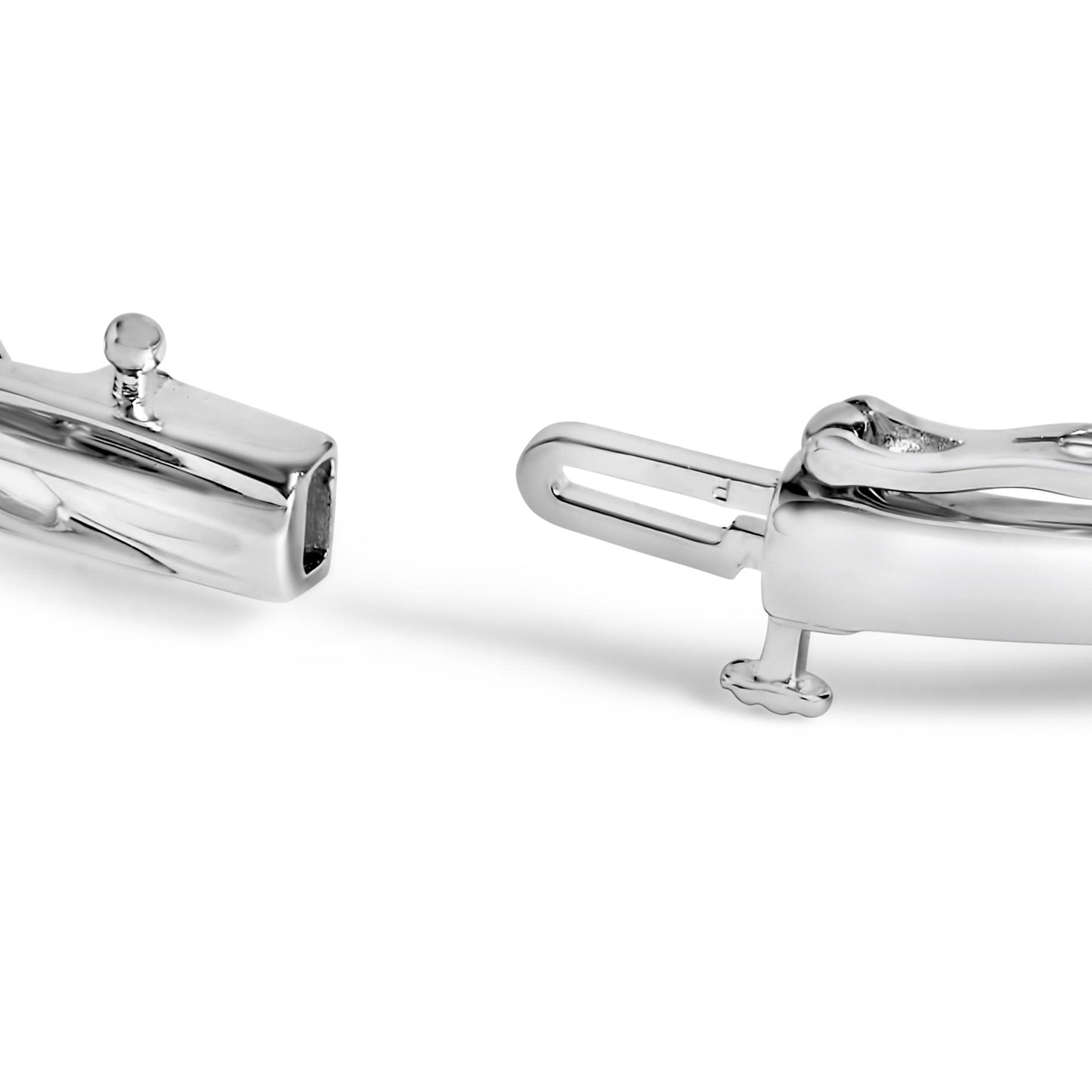 Close-up front angle of a white metal bracelet clasp with shared prong-set round black and white gemstones.