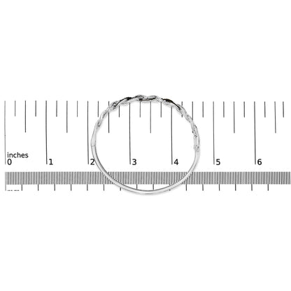 Bracelet with intertwined design featuring round black and white gemstones in shared prong settings, shown in top view on a scale.