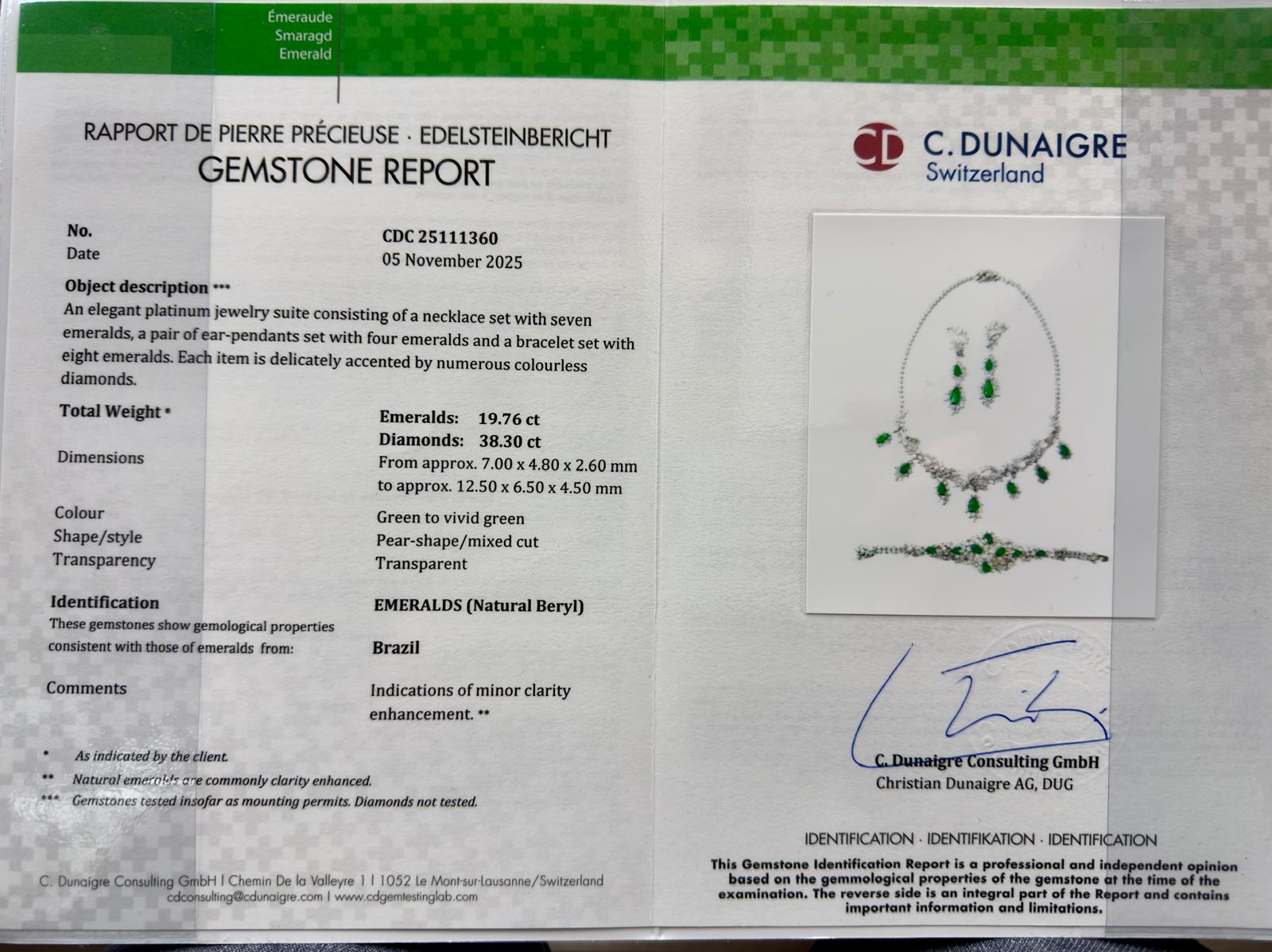 Image of a jewelry set shown on a white background, consisting of a necklace, a pair of earrings, and a bracelet. Each piece features pear-shaped green gemstones and numerous small white gemstones arranged delicately. The necklace has green gemstones hanging in a symmetrical design, the earrings each have two dangling green gemstones, and the bracelet displays green gemstones centered with white gemstones surrounding them. The shot is taken from above, showing the layout of the entire set clearly.