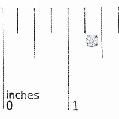 Close-up front angle of a single white metal stud earring featuring a round white gemstone in a four-prong setting, shown on a scale with inches marked.