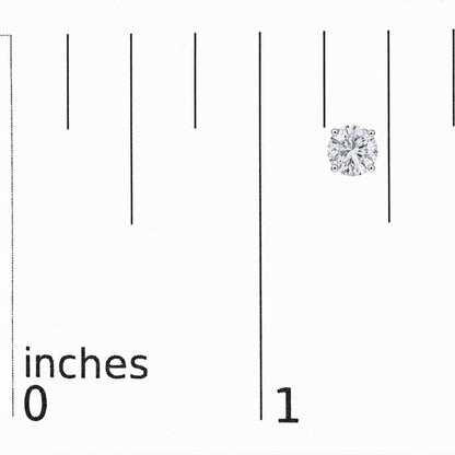 Close-up image of a single white metal stud earring with a round white gemstone in a 4-prong setting, shown on a vertical ruler scale.