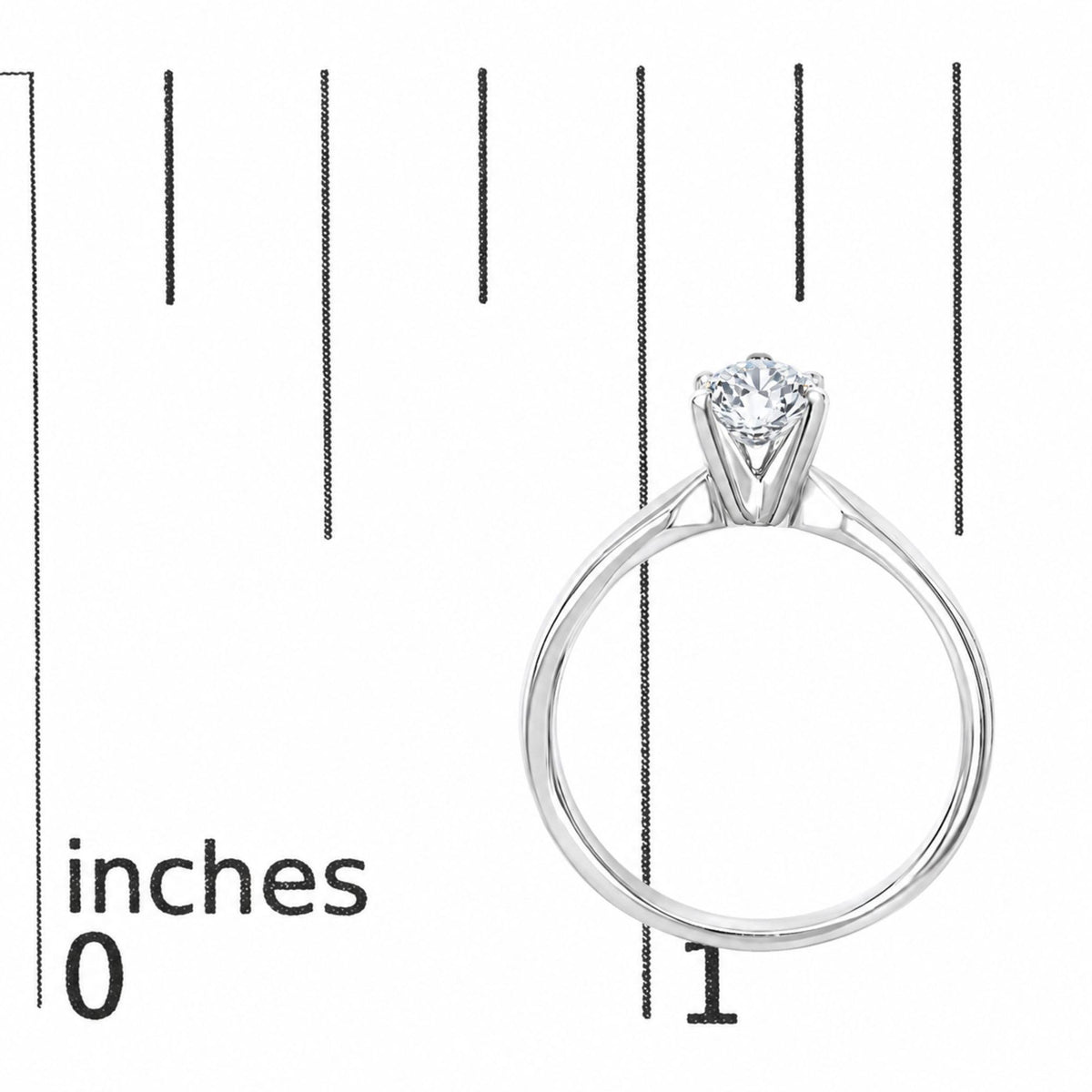 Close-up front view of a white metal ring with a round white gemstone in a 4-prong setting, shown on a scale.
