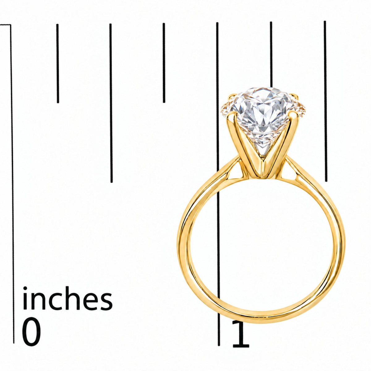Close-up front angle of a yellow metal ring with a round white gemstone in a four-prong setting, shown on a measurement scale.
