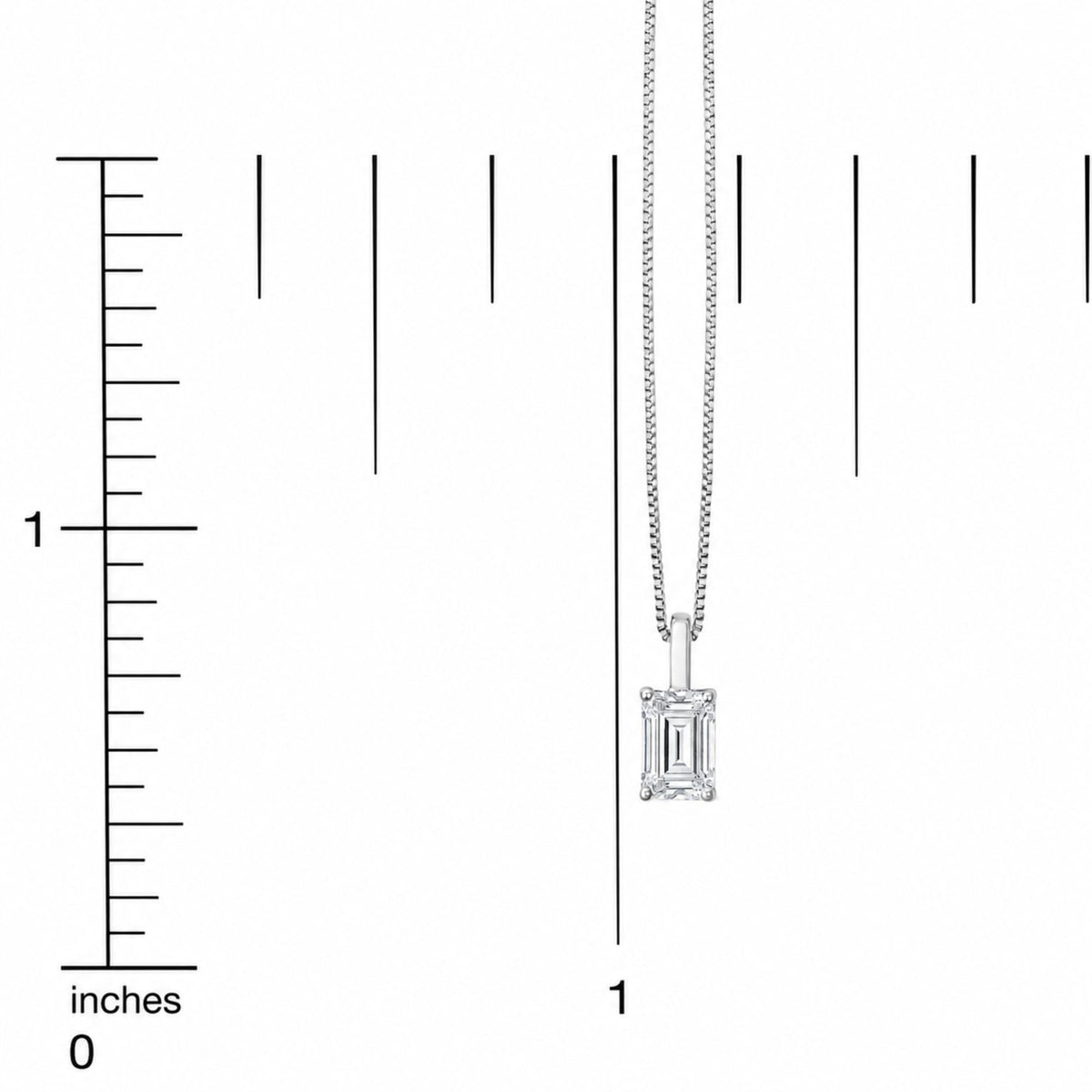 Close-up front view of a white metal necklace with a vertical emerald-shaped white gemstone pendant, shown on a scale.