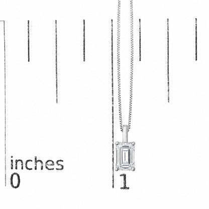 Close-up front view of a white necklace with an emerald-shaped white gemstone pendant set in four prongs, shown on a scale with measurement markings.
