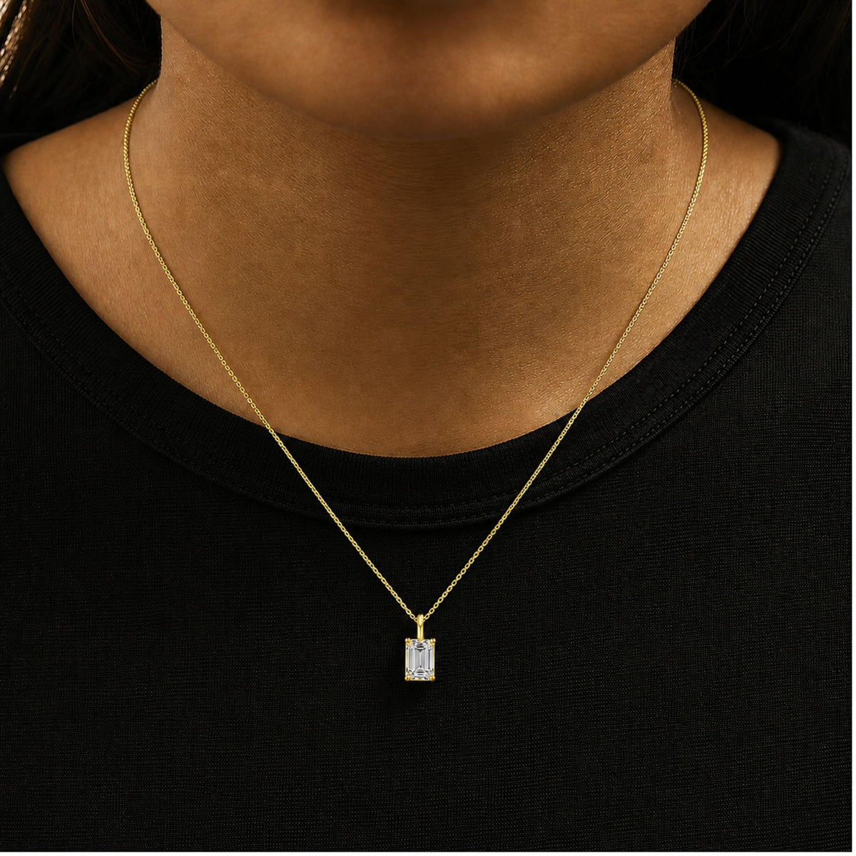 Close-up front view of a model wearing a yellow necklace with a rectangular white gemstone pendant in a 4-prong setting.