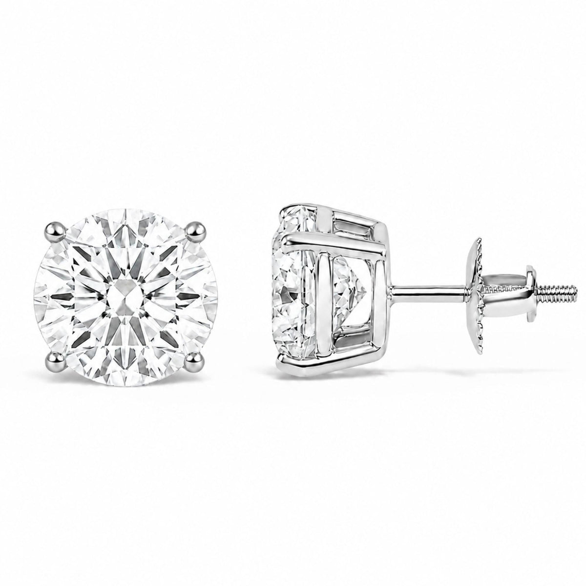 Close-up front and side view of a pair of white metal stud earrings each featuring a round white gemstone set in a four-prong setting, image taken against a white background.