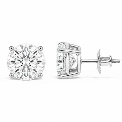 Close-up front and side view of a pair of white metal stud earrings each featuring a round white gemstone set in a four-prong setting, image taken against a white background.