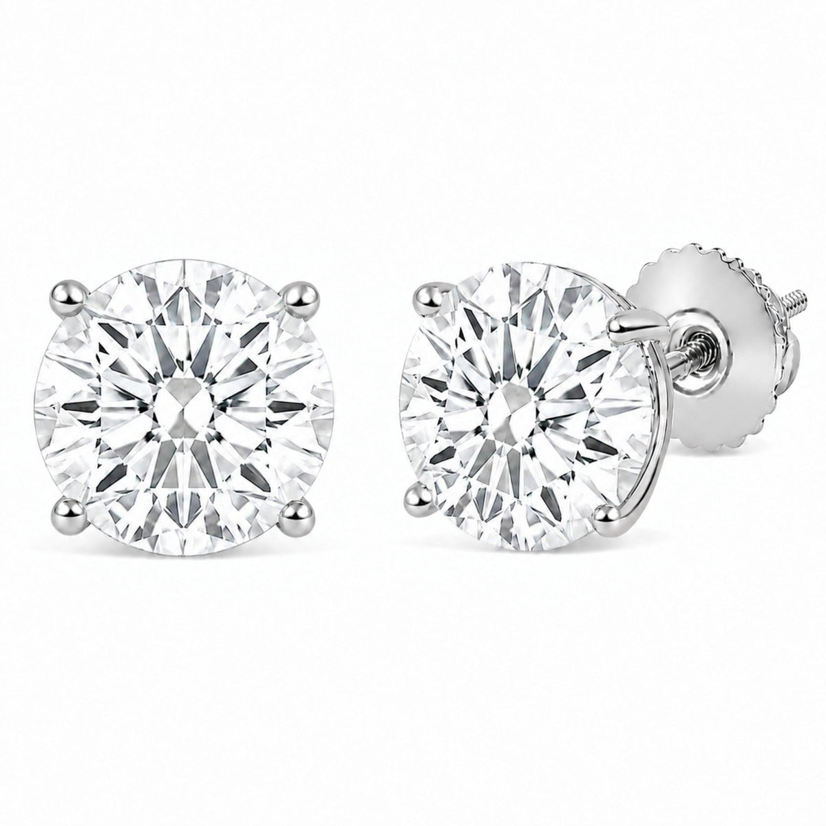 Close-up front angle of a pair of white stud earrings with round white gemstones held in 4-prong settings, shown on a white background.