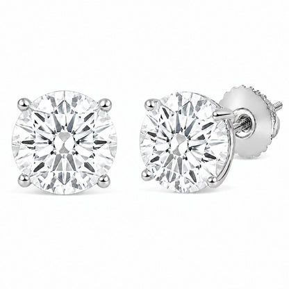 Close-up front angle of a pair of white stud earrings with round white gemstones held in 4-prong settings, shown on a white background.