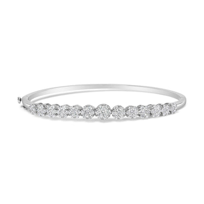 White metal bracelet with multiple clusters of round white gemstones in prong settings, shown in a front angled view.