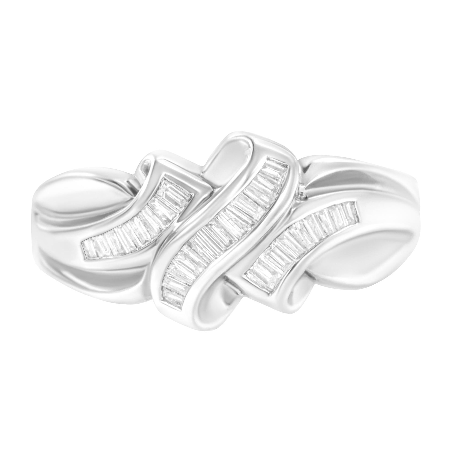 Close-up front angle of a white metal ring featuring three intertwined bands adorned with channel-set white baguette-shaped gemstones.