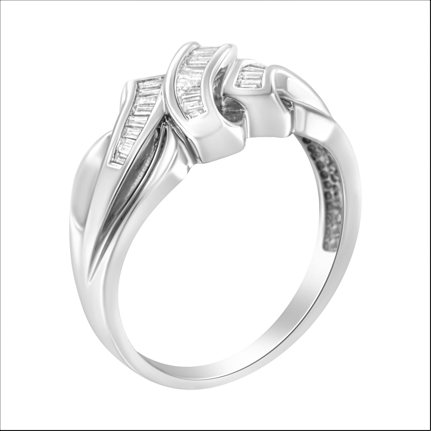 White metal ring with channel set baguette shaped white gemstones, shown at an angled close-up view.