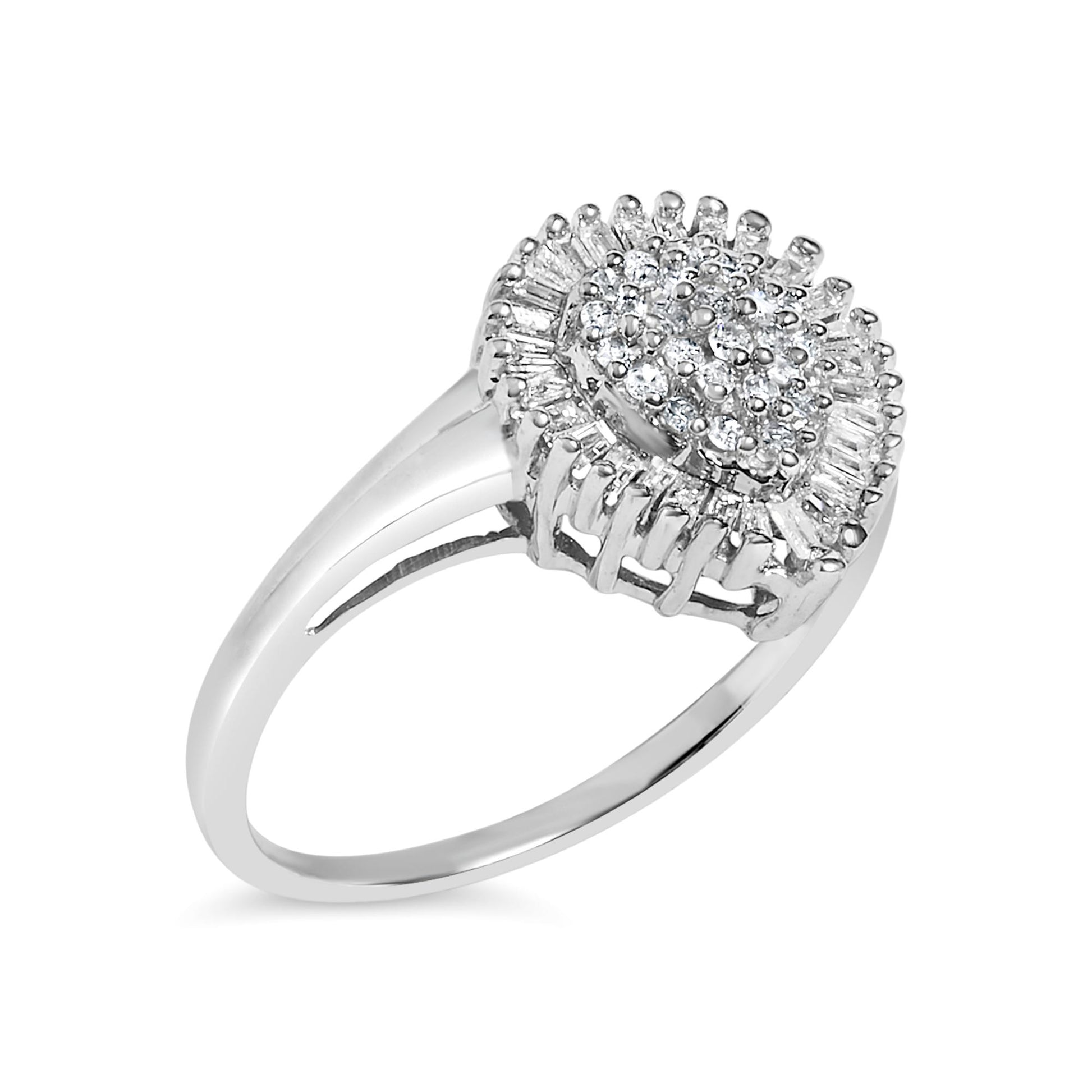 White metal ring with a cluster of round white gemstones in a prong setting surrounded by a halo of baguette white gemstones in a channel setting, shown at a slight angle.