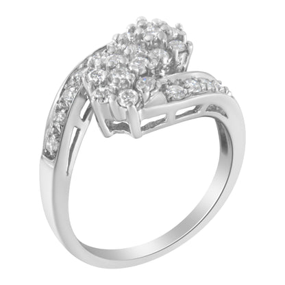 White metal ring with round white gemstones in prong settings, viewed from an angled top perspective.