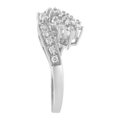 Side view of a white metal ring with multiple round white gemstones in prong settings arranged on the upper part.