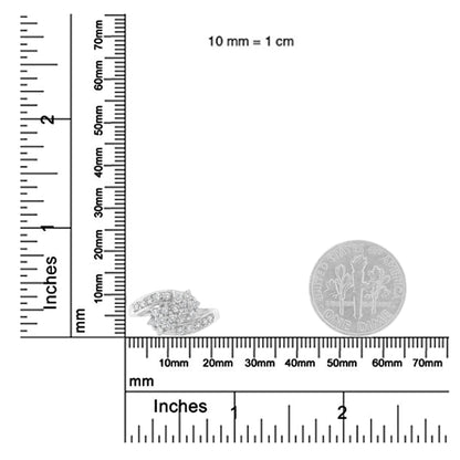 White metal ring with cluster of round white gemstones in prong setting, shown from an angled top view, placed on rulers and next to a coin for size reference.