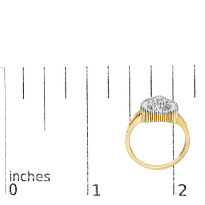 Yellow metal ring with cluster of white round gemstones in prong settings and white baguette gemstones in channel settings, shown from front on top view on a ruler for size reference.