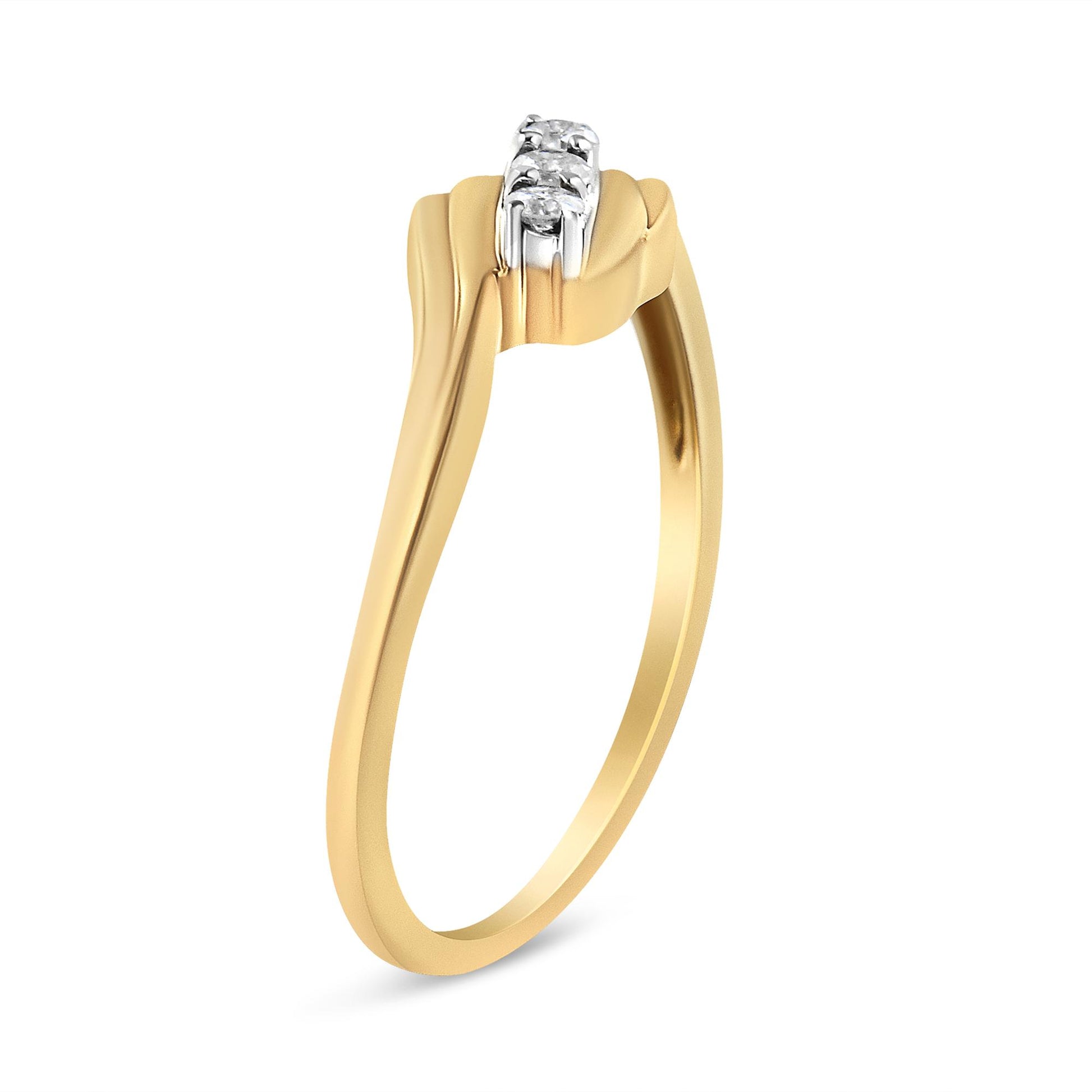 Yellow metal ring with three round white gemstones in prong setting, shown from a side angle.
