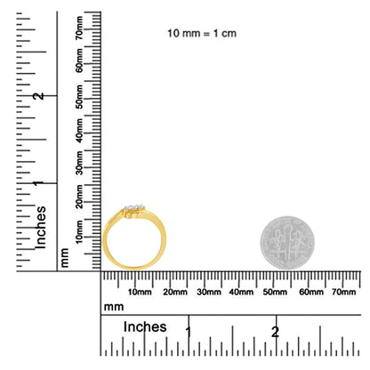 Yellow metal ring with three round white gemstones in prong settings, shown from side angle on a ruler for size reference.