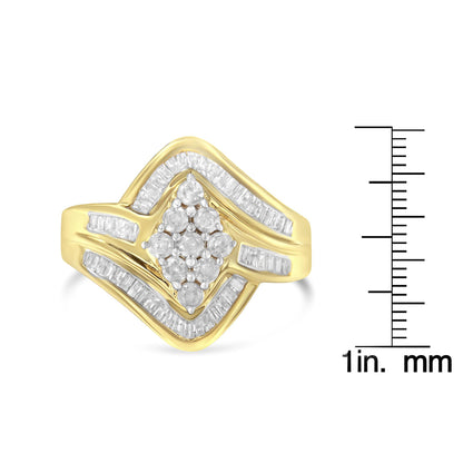 Yellow metal ring with white round prong-set gemstones clustered in the center and white baguette channel-set gemstones forming a wave pattern around them, shown in a front angle view, placed next to a ruler for size reference.