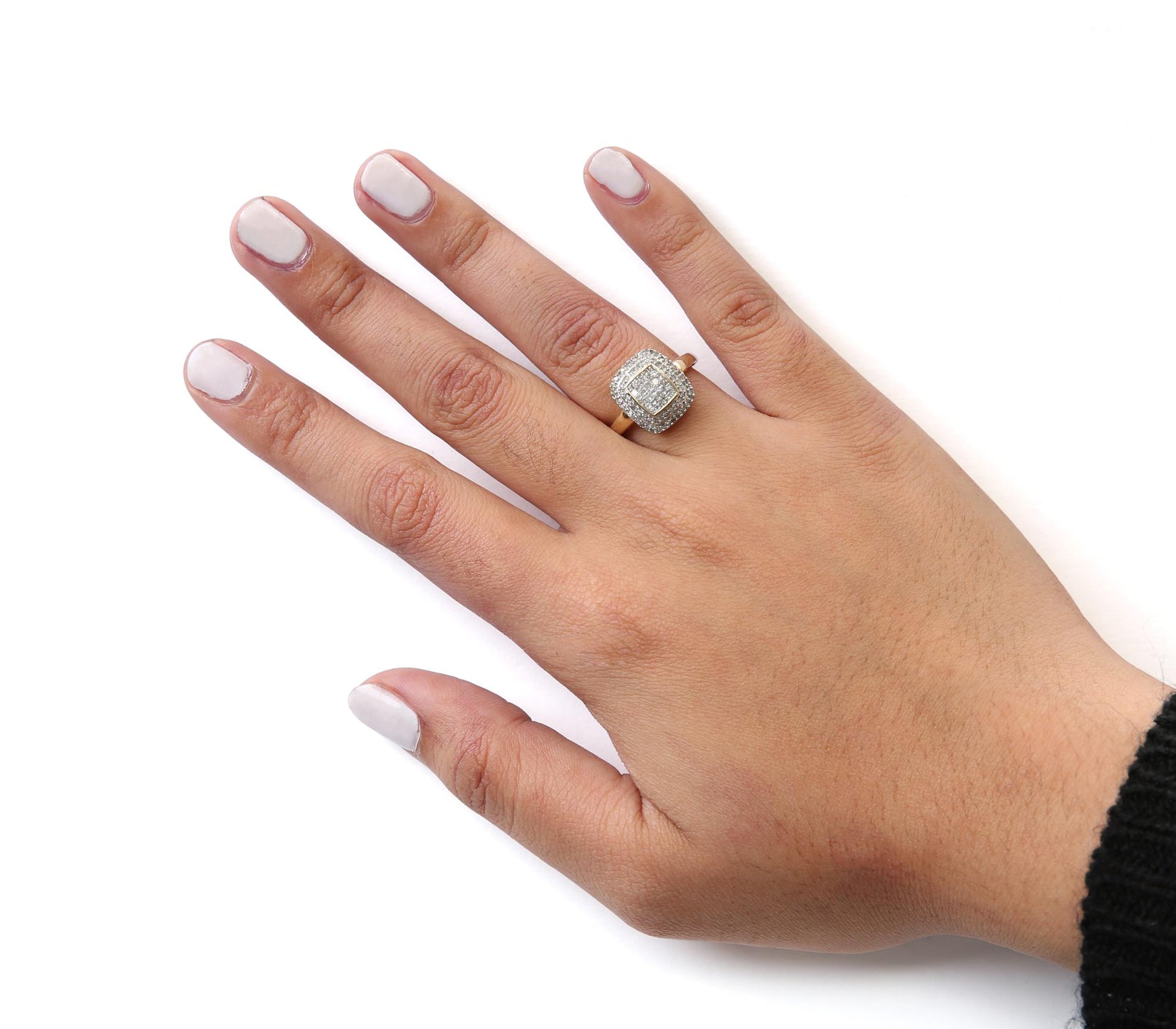 Yellow metal ring with a square cluster of white gemstones in round pave and princess invisible settings, worn on a hand shown from above at an angle.