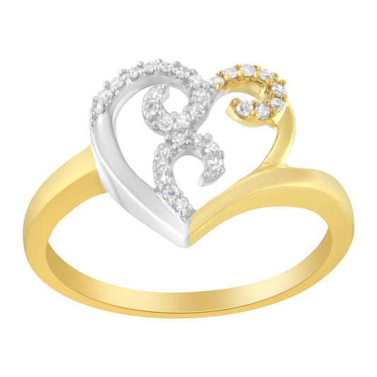 Close-up angle of a two-tone ring with a heart-shaped design featuring white gemstones in prong settings on the upper part of the heart.