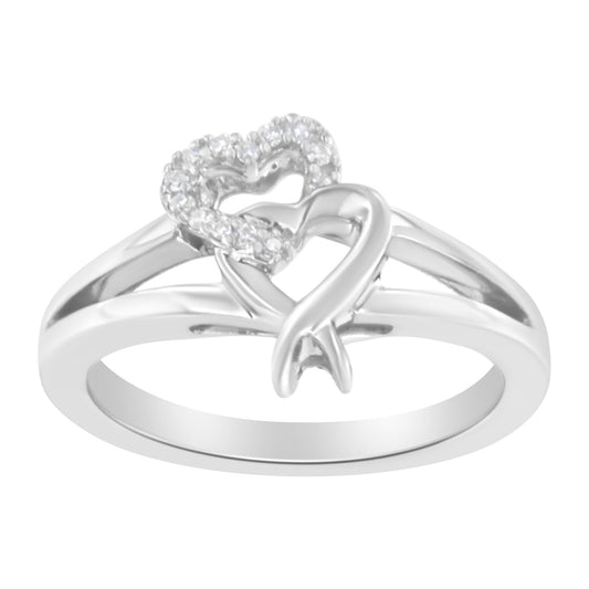 White metal ring with intertwined hearts, one heart adorned with small prong-set round white gemstones, shown from a front angle.