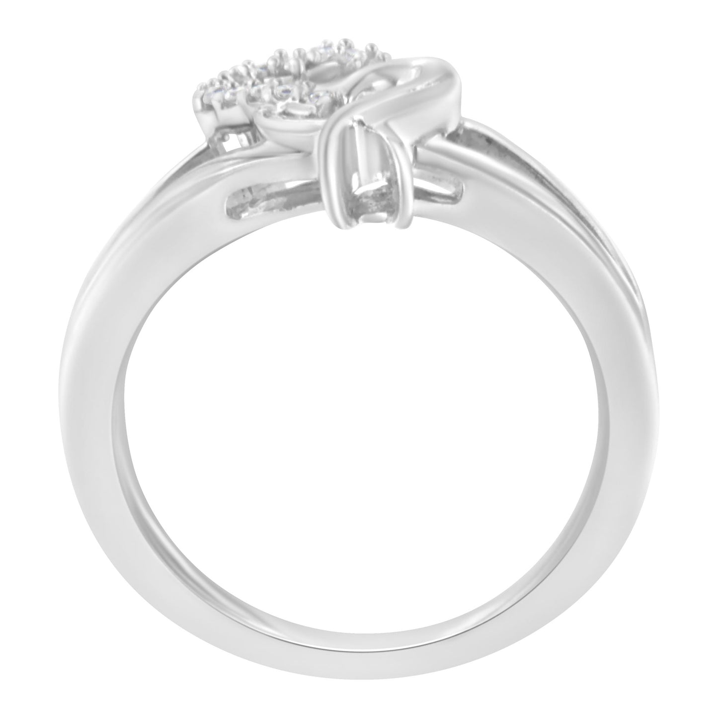Side view of a white metal ring featuring multiple round white gemstones in a prong setting on the top.