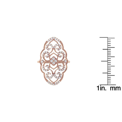 Top-down view of an elongated ornate rose-colored ring with intricate scrollwork adorned with multiple round white gemstones in prong settings, shown next to a ruler for size reference.