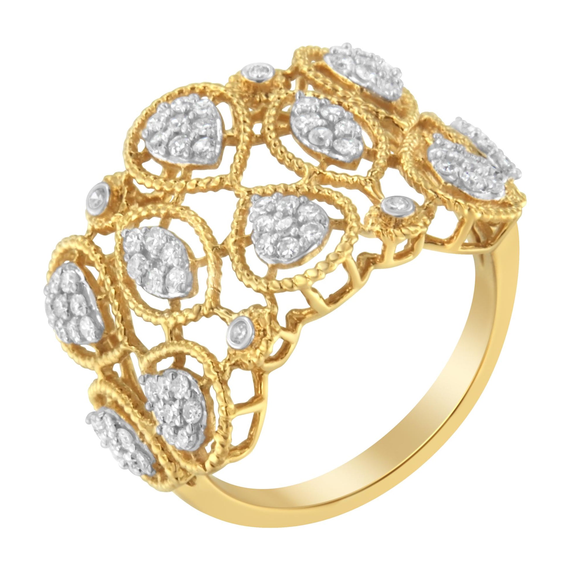 Yellow metal ring with intricate openwork design, featuring clusters of round white gemstones in pave setting, shown at an angled close-up.