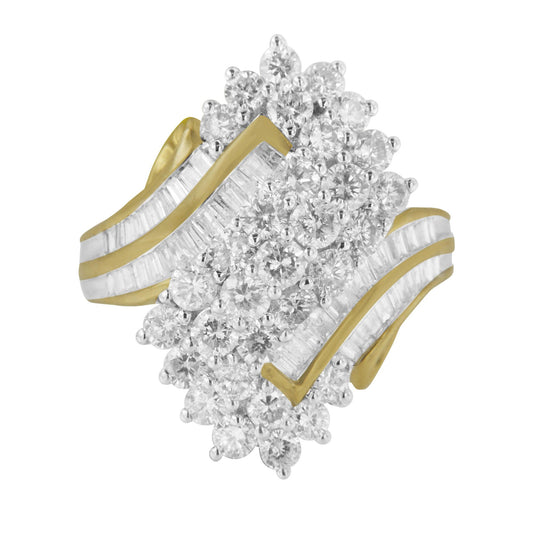 Yellow metal ring with cluster of round white gemstones in prong setting and baguette white gemstones in channel setting, shown from an angled top view.