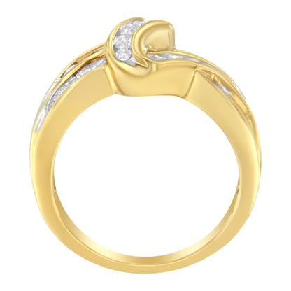 Front view of a yellow metal ring featuring channel-set white round and baguette gemstones along the band.
