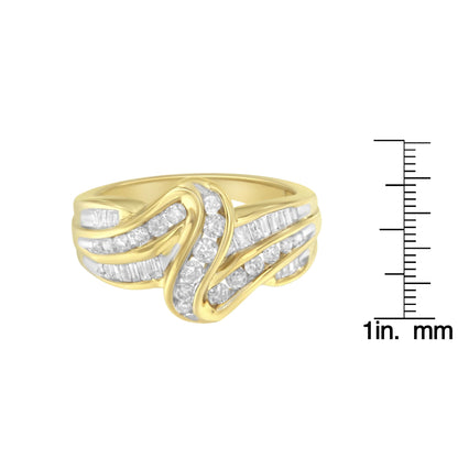 Yellow metal ring with flowing bands of channel-set white round and baguette gemstones, shown in a front-facing view next to a size reference ruler.