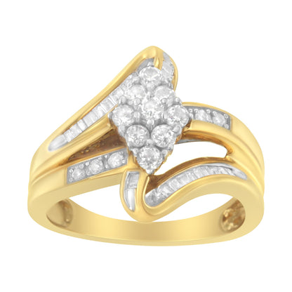 Yellow metal ring with round white gemstones in prong settings forming a cluster at the center and baguette white gemstones in channel settings along the band, shown in a front angled close-up.