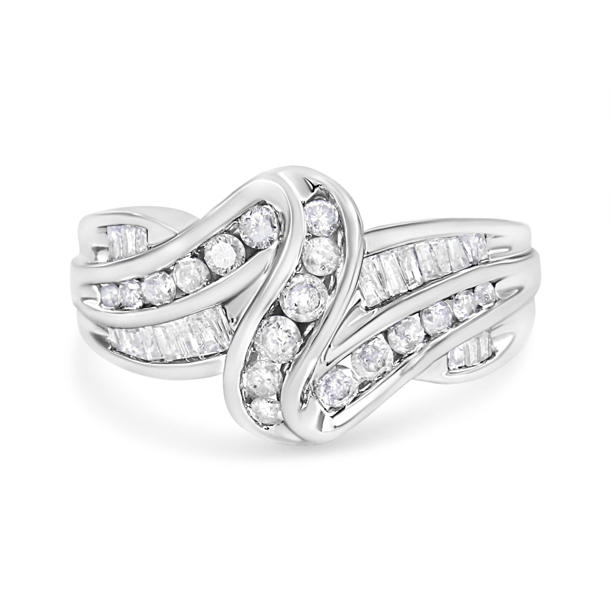 Front view of a white metal ring with curved bands set with channel-set round white gemstones and baguette-shaped white gemstones.