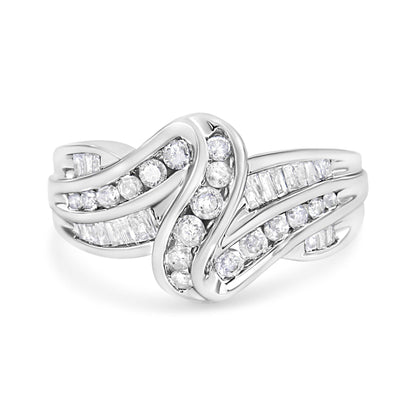 Front view of a white metal ring with curved bands set with channel-set round white gemstones and baguette-shaped white gemstones.