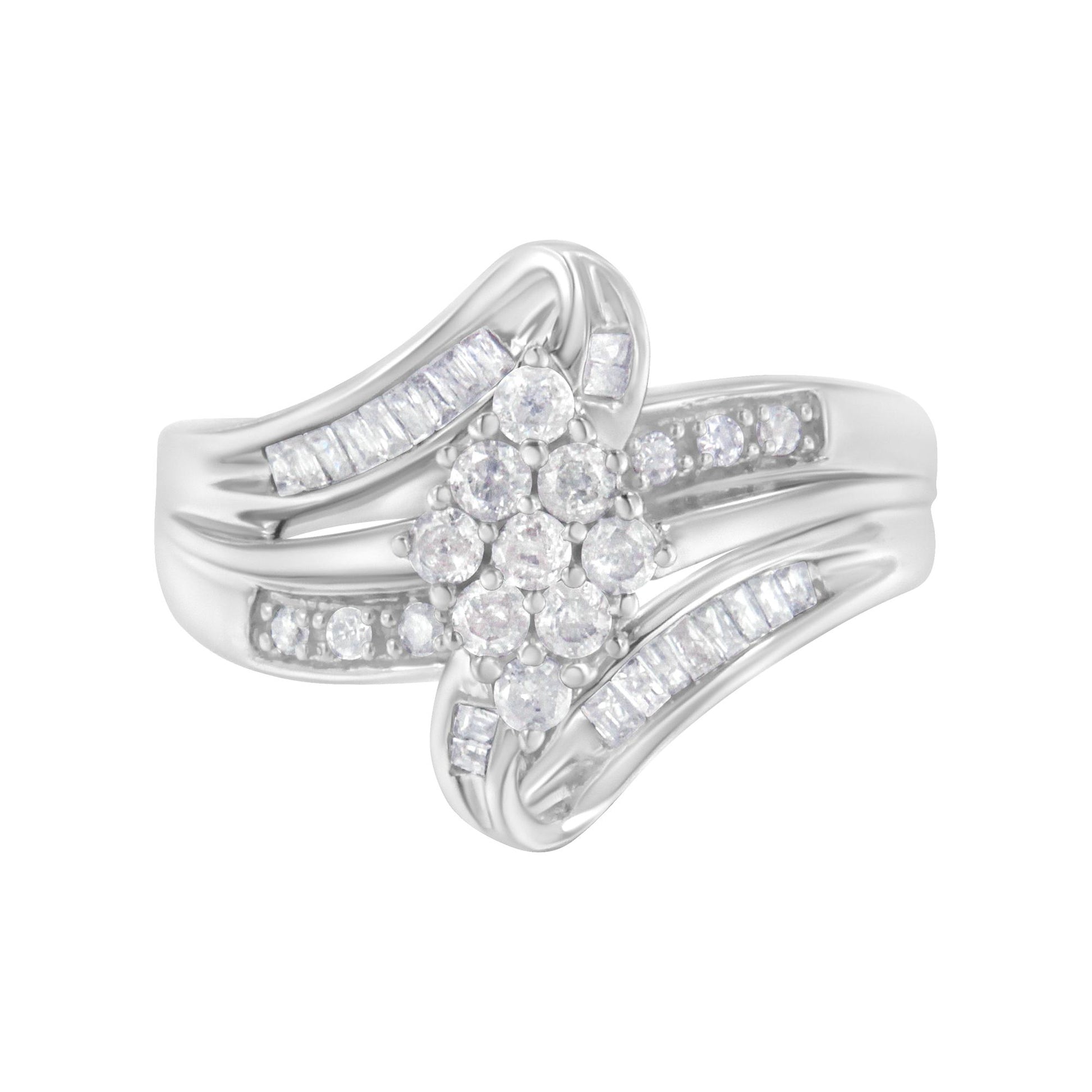 White metal ring with a cluster of round white gemstones in prong settings in the center, flanked by baguette-shaped white gemstones in channel settings along the split shank, shown in a front-facing close-up angle.