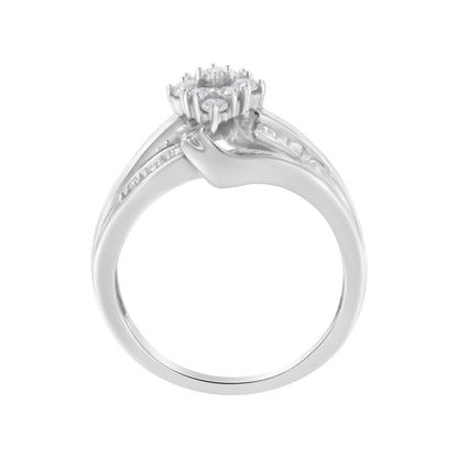 Front angle view of a white metal ring with a cluster of round white gemstones in prong settings and baguette white gemstones in channel settings along the band.