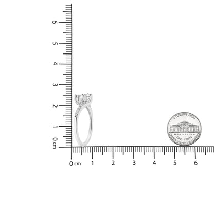 White metal ring with two round white gemstones in a miracle setting and multiple smaller round white gemstones in a prong setting along the band, photographed upright on a ruler for size reference.